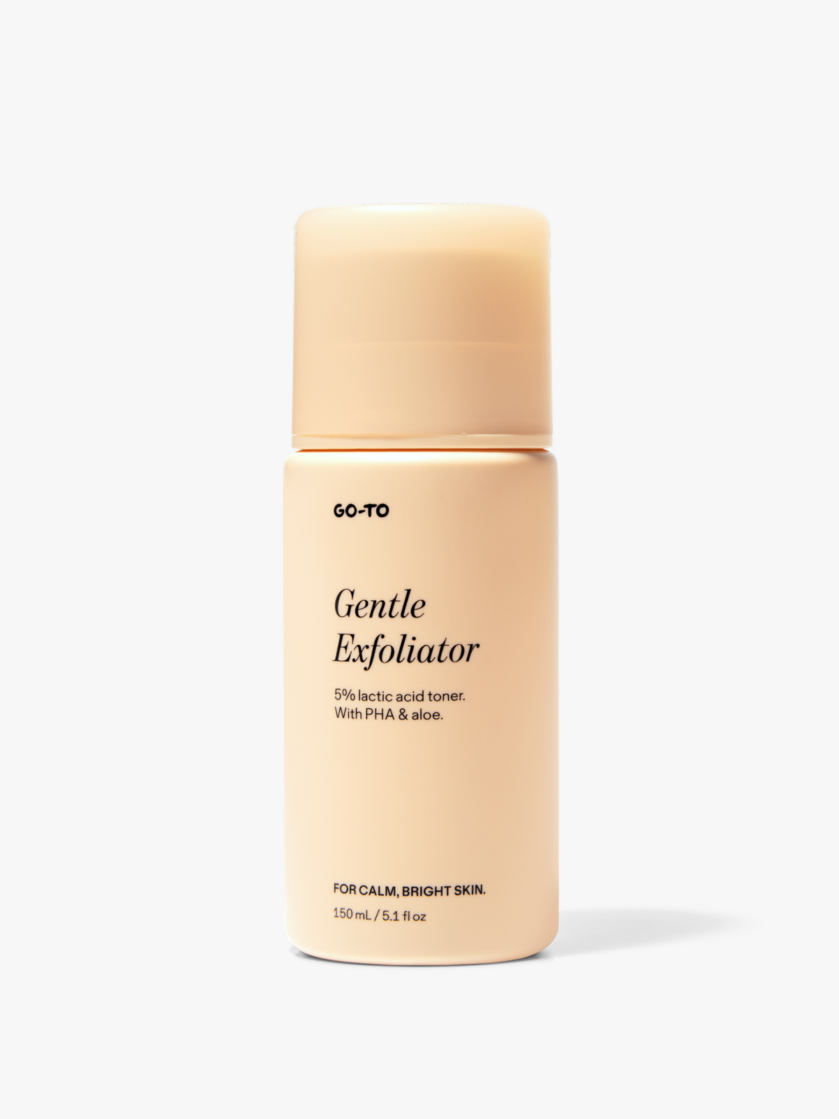 Go-To Skincare Gentle Exfoliator toner bottle with a warm beige label and matching cap, shown upright on a white background