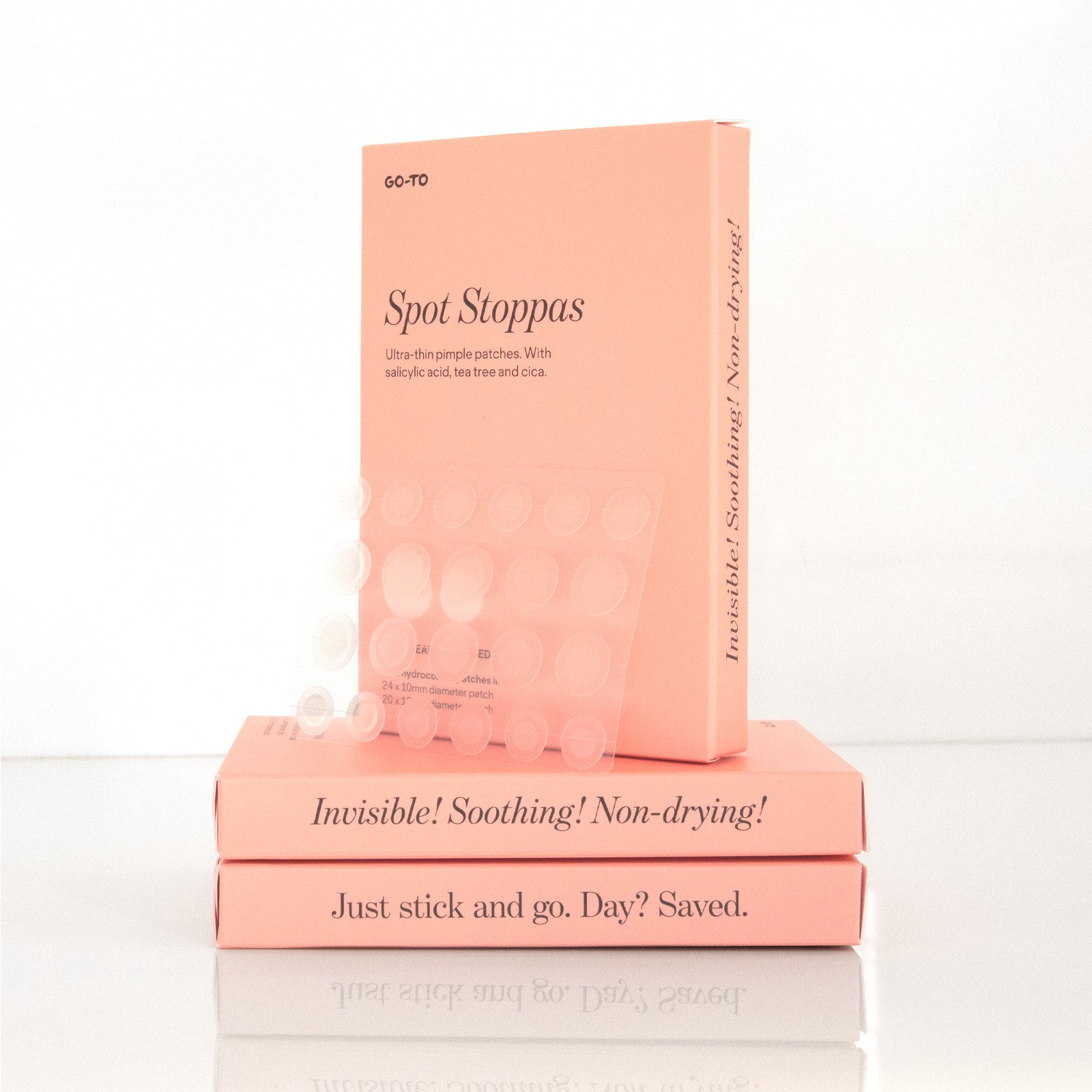 A peach box labeled “Spot Stoppas” by Go-To Skincare, featuring 44 ultra-thin hydrocolloid pimple patches with salicylic acid, tea tree, and cica—24 small and 20 large—for targeted spot treatment.