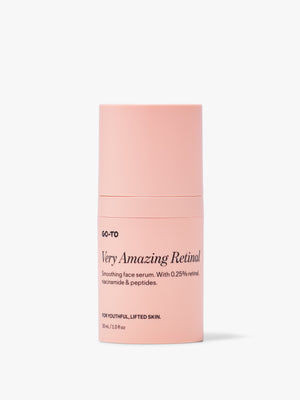 A bottle of Go-To Properly Clean facial cleanser featuring its signature peachy-pink packaging and pump dispenser.