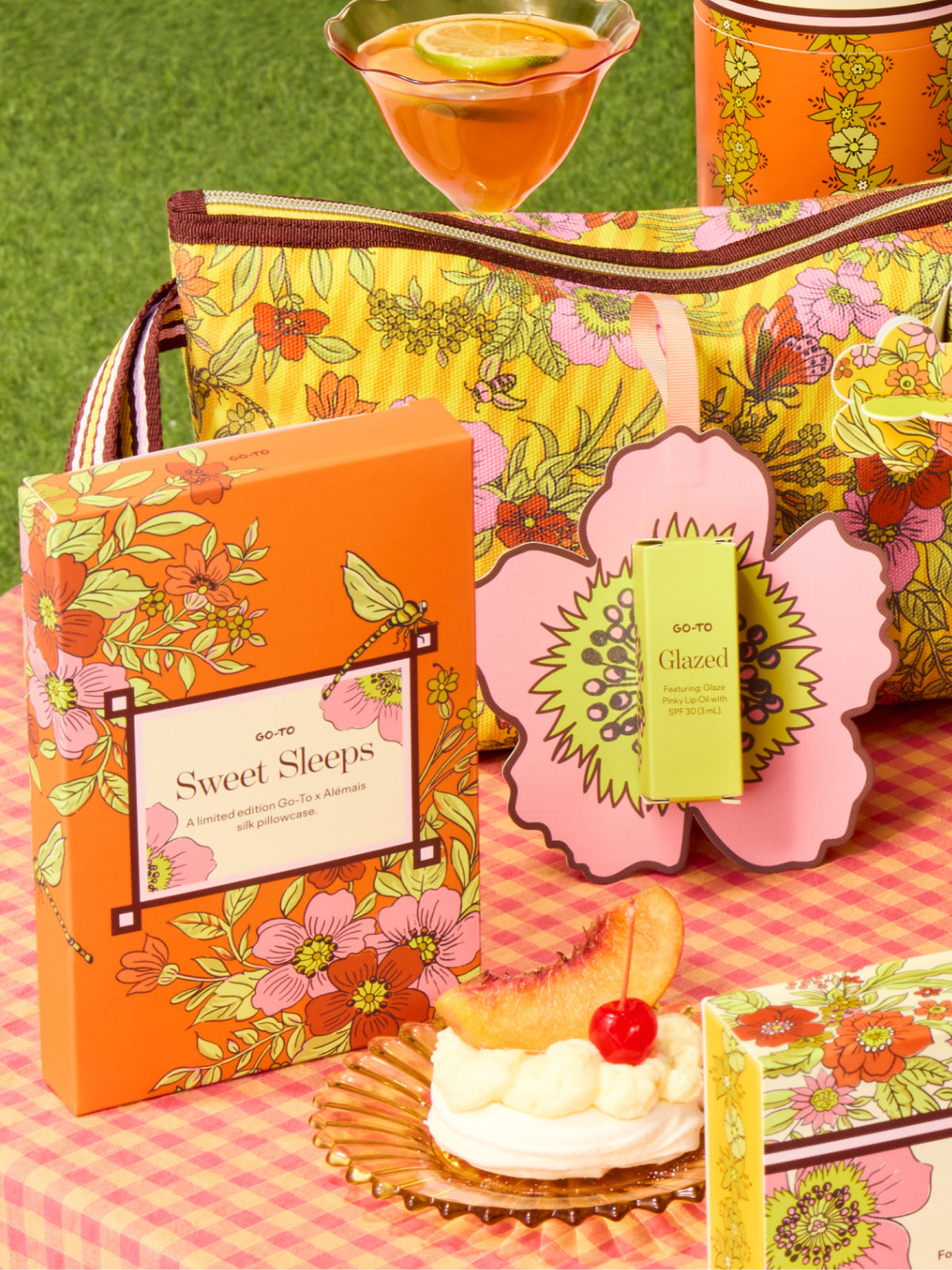 Go To Skincare Sweet Sleeps floral gift set with a patterned box matching zip pouch and Glazed skincare tube styled with a cocktail and dessert