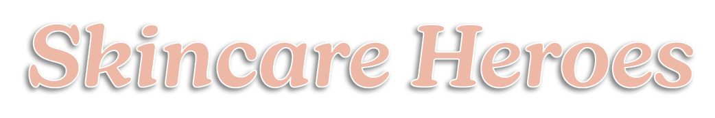 The image displays the words Skincare Heroes in large, soft peach-colored text with a subtle shadow on a light gray background.